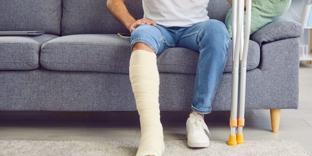 A,Man,With,A,Broken,Leg,Sits,On,The,Sofa slip and fall accident attorney