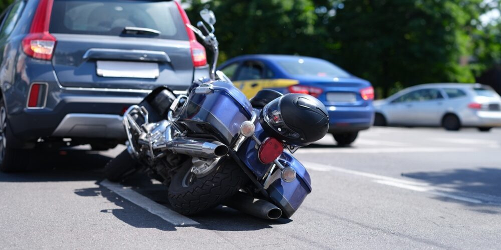 Blue,Motorcycle,Lying,On,Road,Near,Car,Closeup.,Road,Traffic Wilkes-Barre personal injury attorney